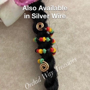 May include: Gold hair beads with a red, yellow, and green color scheme. The beads are on a black braid. The text "Also Available in Silver Wire" is at the top of the image. The text "Orchid Way Treasures" is at the bottom of the image.