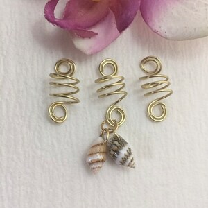 This is a set of 3 gold dreadlock, twists, loc, or braid charms--one featuring two natural shells dangling from the coil.  Size: Opening in coils as shown is 8mm.  Made with 20g tarnish resistant gold wire.   Being natural shells, color and size will vary.   ***If you prefer silver, copper, or bronze wire vs. gold wire, just add a "note to seller" at checkout with your wire color choice.