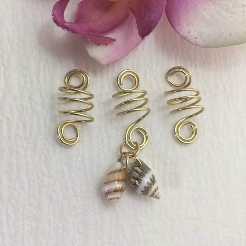 This is a set of 3 gold dreadlock, twists, loc, or braid charms--one featuring two natural shells dangling from the coil.  Size: Opening in coils as shown is 8mm.  Made with 20g tarnish resistant gold wire.   Being natural shells, color and size will vary.   ***If you prefer silver, copper, or bronze wire vs. gold wire, just add a "note to seller" at checkout with your wire color choice.