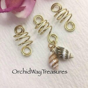This is a set of 3 gold dreadlock, twists, loc, or braid charms--one featuring two natural shells dangling from the coil.  Size: Opening in coils as shown is 8mm.  Made with 20g tarnish resistant gold wire.   Being natural shells, color and size will vary.   ***If you prefer silver, copper, or bronze wire vs. gold wire, just add a "note to seller" at checkout with your wire color choice.