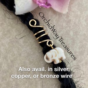 May include: Gold wire dreadlock bead with a white elephant charm. Also available in silver, copper, or bronze wire.