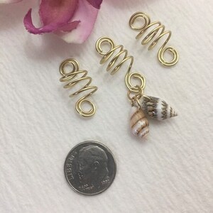 This is a set of 3 gold dreadlock, twists, loc, or braid charms--one featuring two natural shells dangling from the coil.  Size: Opening in coils as shown is 8mm.  Made with 20g tarnish resistant gold wire.   Being natural shells, color and size will vary.   ***If you prefer silver, copper, or bronze wire vs. gold wire, just add a "note to seller" at checkout with your wire color choice.