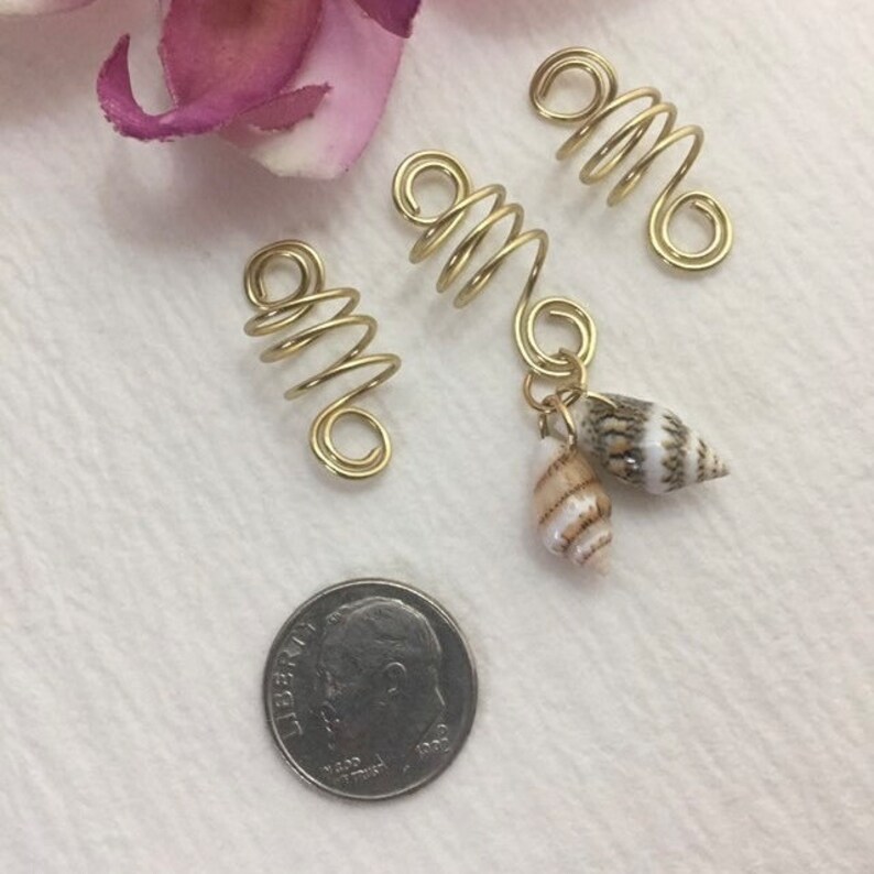 This is a set of 3 gold dreadlock, twists, loc, or braid charms--one featuring two natural shells dangling from the coil.  Size: Opening in coils as shown is 8mm.  Made with 20g tarnish resistant gold wire.   Being natural shells, color and size will vary.   ***If you prefer silver, copper, or bronze wire vs. gold wire, just add a "note to seller" at checkout with your wire color choice.