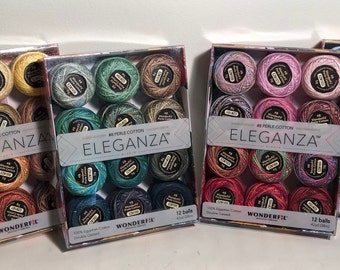May include: Four boxes of Wonderfil Eleganza #8 Perle Cotton embroidery thread. Each box contains 12 balls of thread in various colors. The boxes have a silver and white design with the brand name and thread type printed on the front.