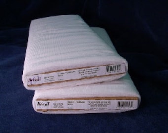 May include: Two rolls of white fabric are stacked on top of each other. The fabric is tightly rolled and appears to be a textured material. Each roll has a label with text and a barcode.