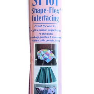 May include: White roll of Pellon SF101 Shape-Flex Interfacing. The pink label features the brand name, product details, and examples of use, including T-shirt quilts and handbags. The roll measures 15 inches by 2 yards.