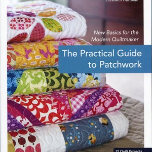 May include: A stack of colorful quilts with various patterns, including floral and geometric designs. The book "The Practical Guide to Patchwork" is visible, along with the author's name, Elizabeth Hartman. The book cover features a stack of quilts with the text "12 Quilt Projects".