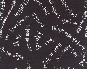 May include: Black fabric with white text featuring Halloween-themed words like "spooky," "candy," "ghosts," and "trick or treat." The words are arranged in a scattered pattern across the surface.