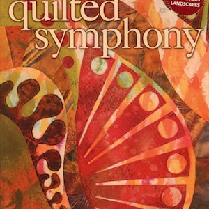 May include: The cover of "Quilted Symphony" by Gloria Loughman features a vibrant, abstract design in shades of orange, red, and brown. The title is prominently displayed, with additional text indicating the author and a tagline: "A Fusion of Fabric, Texture & Design."