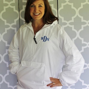 May include: White hooded jacket with a zipper closure and a kangaroo pocket. The jacket has a blue embroidered monogram "WDN" on the front.