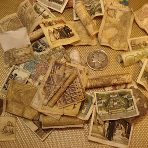May include: A collection of vintage maps and scrolls, some rolled up and tied with twine, others laid flat. The maps are printed on aged paper with a cream color and feature intricate details. A silver coin is visible in the center of the image.