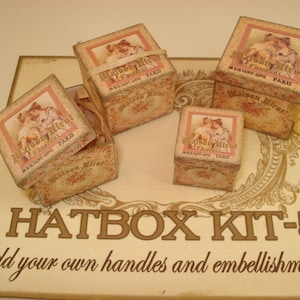 May include: A set of four hatbox kits with a vintage design. Each box features a floral pattern and the text "Maison Mirot Le Grand Luxe" with the address "58 Rue Saint-Anne Paris". The boxes are labeled "Hatbox Kit-5" and the text "add your own handles and embellishments!" is printed below.