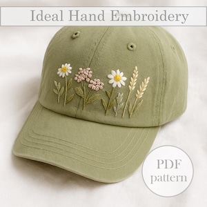 May include: A khaki green baseball cap featuring embroidered flowers, such as daisies and wheat. The text "Ideal Hand Embroidery" is above the cap, and "PDF pattern" is in a circle on the right side.