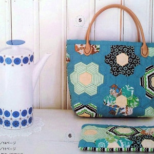 May include: A blue and white patterned teapot with a white lid and a blue and green patchwork tote bag with a brown leather handle. The tote bag has a matching blue and green patchwork zippered pouch.