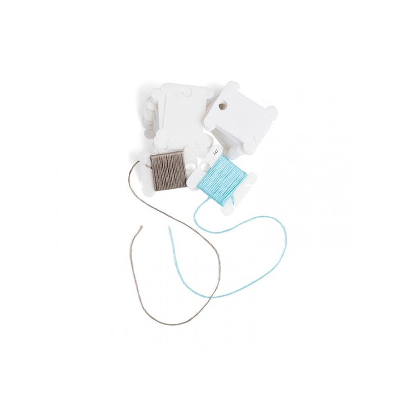 May include: Two spools of thread, one light blue and one gray, are wound around white plastic thread bobbins. The bobbins are stacked on top of each other.
