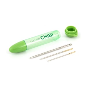 May include: A set of Clover Chibi needles with a green plastic tube and cap. The tube is translucent with the text "CLOVER CHIBI" printed on it. Three needles of varying sizes are next to the tube.