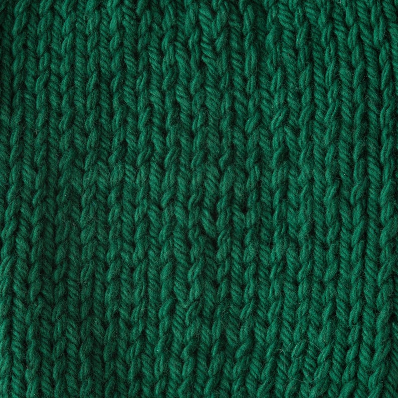 May include: Close-up of a deep green knitted fabric with a textured, cable knit pattern.