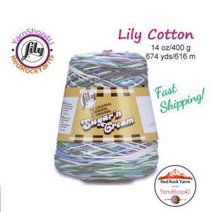 May include: A cone of Lily Sugar'n Cream cotton yarn in pastel colors of blue, green, purple, and white. The label reads "Lily Cotton" and "Sugar'n Cream". The yarn weighs 14 oz (400 g) and is 674 yds (616 m).
