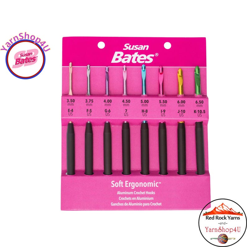 May include: A set of Susan Bates Soft Ergonomic aluminum crochet hooks in a pink package. The hooks range in size from 3.50 mm (E-4 US) to 6.50 mm (K-10.5 US) and feature black ergonomic handles. The package includes the text "Soft Ergonomic".