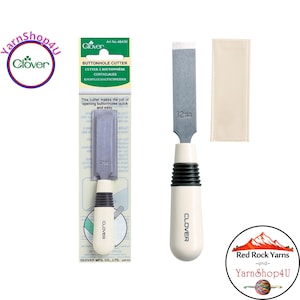 May include: A Clover buttonhole cutter with a 12mm blade. The cutter has a white handle with black grip rings and the Clover logo. The packaging includes the text "BUTTONHOLE CUTTER" and "This cutter makes the job of opening buttonholes quick and easy."