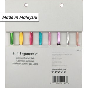 May include: A package of Soft Ergonomic aluminum crochet hooks in various colors, including green, yellow, pink, and blue. The text "Made in Malaysia" is visible. The package also includes text in French and Spanish.