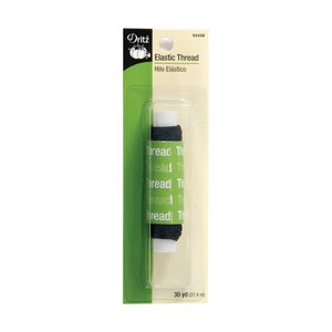 May include: A spool of black elastic thread by Dritz, packaged on a cream and green card. The packaging displays the text Elastic Thread, Hilo El&aacute;stico, and 30 yd (27.4 m). The spool is encased in a clear plastic blister pack with a hanging hole.