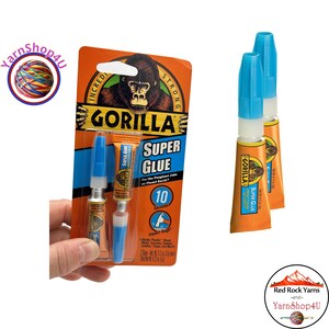 May include: Gorilla Super Glue tubes in orange and blue packaging. The packaging features a gorilla graphic and the text "Super Glue". The glue is designed for the toughest jobs on the planet. The package also includes the text "10 Seconds".