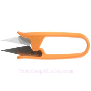 May include: Orange Fiskars snips with silver blades, designed for precision cutting. The handle is a bright orange color, and the blades are made of steel. The snips are ideal for various crafting projects, including yarn and thread.