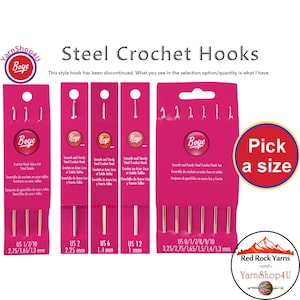 May include: Pink packaging of Boye steel crochet hooks. The packages display various sizes, including US 1/7/10 (2.75/1.65/1.3 mm), US 2 (2.25 mm), US 6 (1.4 mm), US 12 (1 mm), and US 0/1/7/8/9/10 (3.25/2.75/1.65/1.5/1.4/1.3 mm). The text "Steel Crochet Hooks" is visible.