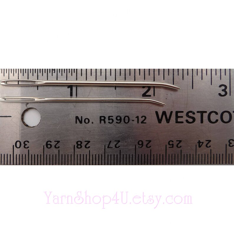 May include: Two silver needles measuring 2 inches long, laid out on a ruler with the text "No. R590-12 WESTCO" printed on it.
