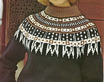 May include: A woman wearing a black sweater with a brown and white patterned yoke. She is wearing a white fur hat and has blonde hair.