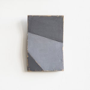 Pequeña escultura de pared abstracta gris, arte texturizado minimalista moderno sobre panel de cartón, decoración geométrica única para el hogar.