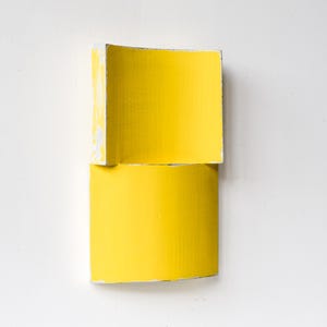 Escultura mural original de cartón reciclado amarillo, arte ecológico minimalista moderno, relieve abstracto contemporáneo en 3D.