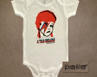 A Tad Insane hand screen printed white, cotton onesie for baby David Bowie fans