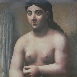 May include: A poster advertising an exhibit of Picasso's work at the Louisiana Museum of Modern Art. The poster features a painting of a nude woman with dark hair and a white drape. The text on the poster reads "Picasso og Middelhavet" and "Louisiana Museum for moderne kunst 20.9.1996 - 19.1.1997".