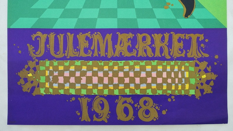 May include: A vintage poster with the text "JULEM&AElig;RKET 1968" in gold lettering. The poster features a purple background with a checkered pattern in the centre and a green checkered pattern at the top. The overall design has a retro aesthetic.