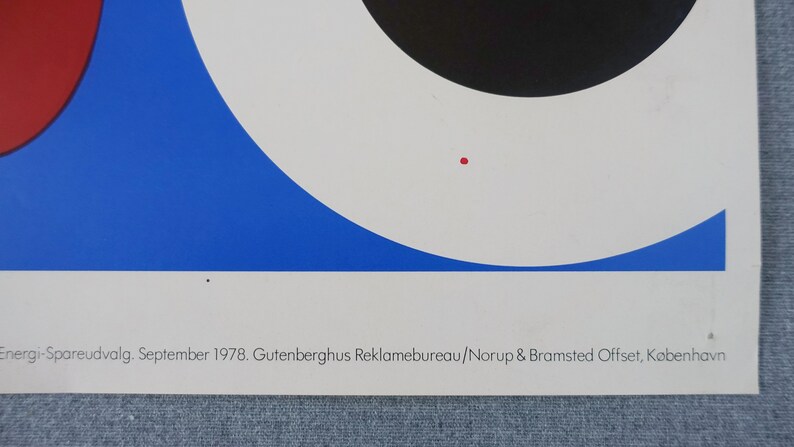May include: A vintage poster with a geometric design featuring a red, black, and blue color scheme. The poster text reads "Energi-Spareudvalg. September 1978. Gutenberghus Reklamebureau/Norup & Bramsted Offset, K&oslash;benhavn."