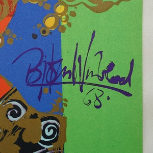 May include: Abstract art print with a signature in purple ink and the number '68'. The artwork features blue, green, gold, and orange colours. The signature appears to be the artist's name.