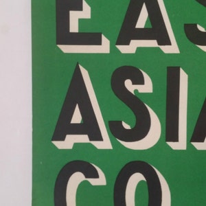 May include: A green poster with the text "EAST ASIA CO." in black and white letters with a 3D effect.