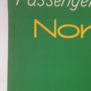 May include: A green poster with the text "Passenger" in white and "Nor" in yellow.