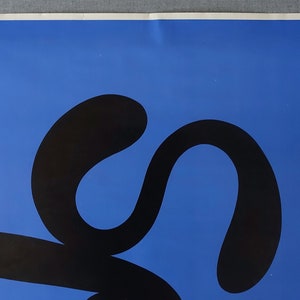May include: A black abstract design on a bright blue background. The design is a series of connected curves and loops.