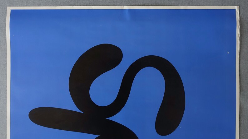 May include: A black abstract design on a bright blue background. The design is a series of connected curves and loops.