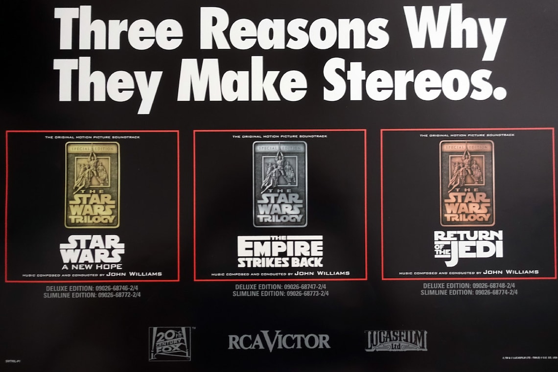 May include: A black and white poster advertising the Star Wars soundtrack albums. The poster features three album covers, each with a different Star Wars movie title: "Star Wars: A New Hope", "The Empire Strikes Back", and "Return of the Jedi". The poster also includes the RCA Victor and Lucasfilm logos.