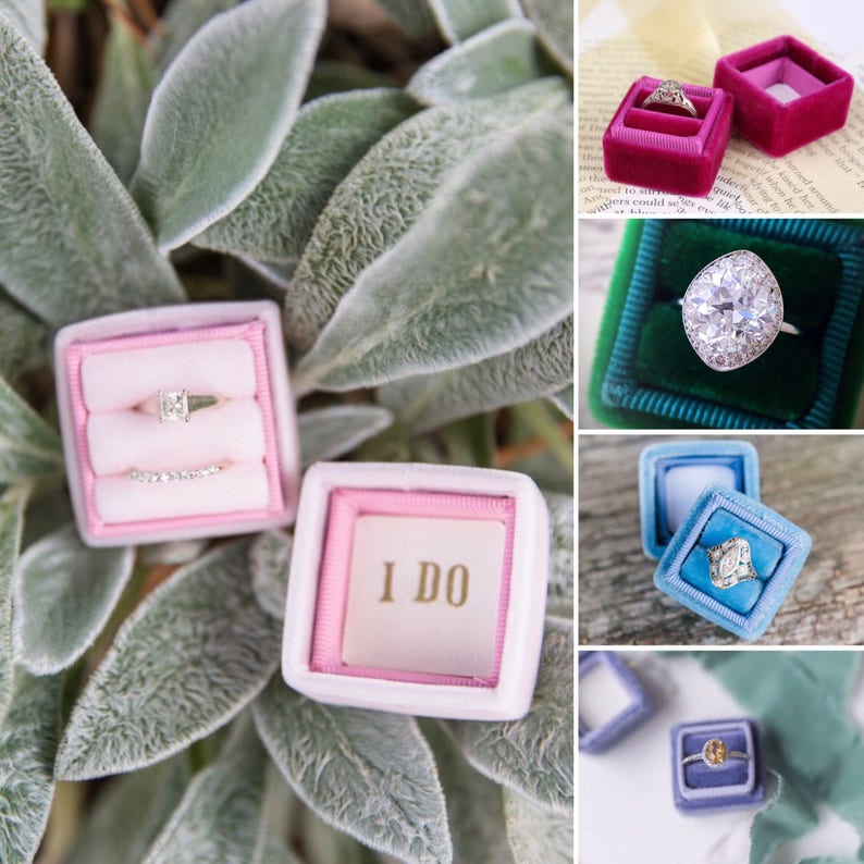 May include: A collection of engagement rings in velvet ring boxes. The boxes are in various colors, including pink, green, and blue. One box has the words "I DO" printed on the inside. The rings feature different stone shapes and settings.