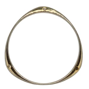 May include: A gold-toned bangle bracelet with a triangular shape. The bracelet features three small, round, clear gemstones evenly spaced around the band. The design is simple and elegant, suitable for everyday wear.