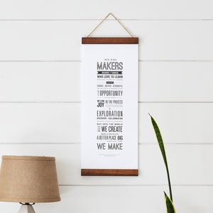 May include: A black and white typography print with the text "We are Makers who love to learn. We find opportunity, joy in the process, exploration, discovery, collaboration. Out into the world we create a better place big we make."