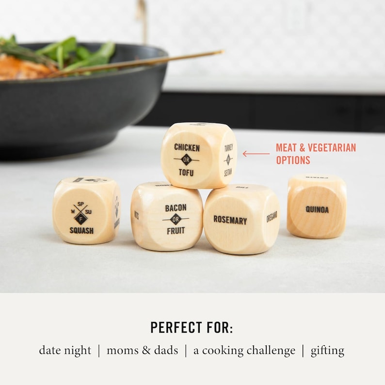 May include: Five wooden dice with different food options printed on each side. The dice are stacked on top of each other. The top die reads "Chicken or Tofu". The other dice read "Bacon or Fruit", "Rosemary", "Squash", and "Quinoa". The text "MEAT & VEGETARIAN OPTIONS" is printed on the image.