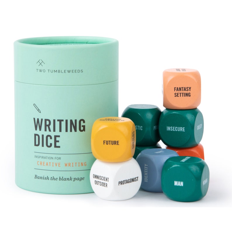 May include: A set of six colorful wooden dice with words like "Future", "Protagonist", "Insecure", and "Fantasy Setting" printed on them. The dice are in a green cylinder container with the words "Writing Dice" and "Banish the blank page" printed on it.