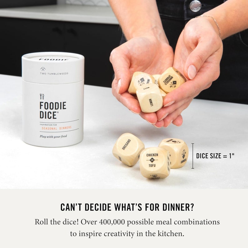 May include: A set of six wooden dice with different food-related words printed on each side. The dice are 1 inch in size and are used to inspire meal combinations. The words on the dice include "chicken", "tofu", "oregano", "lemon", "sprouts", and "russels".