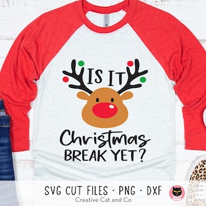 May include: A white and red raglan t-shirt with a cartoon reindeer and the text "IS IT Christmas BREAK YET?" printed on the front.